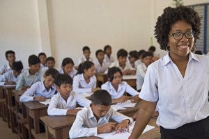 Peace corp worker in front of a classroom