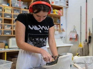 student working on pottery 