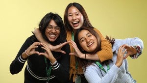 three female students holding up the o shape with their hands