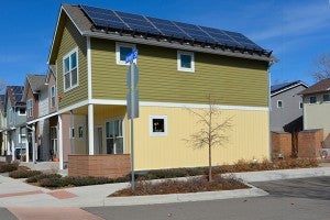 2-story corner house with solar panels on the roof