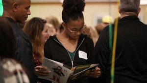 A prospective student reading admissions materials