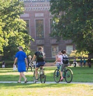 photo of students riding bikes on campus