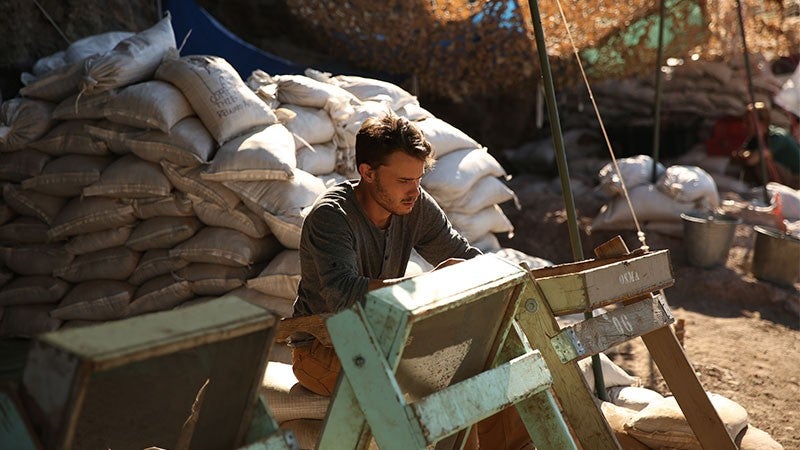 A person working at an archeological dig