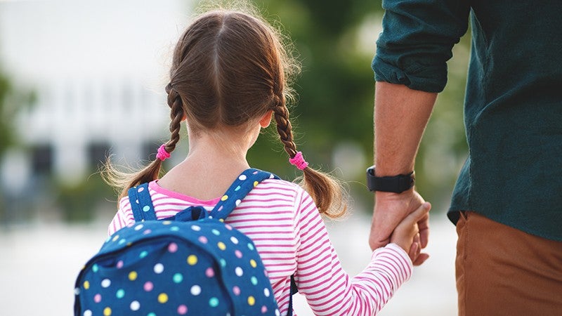 child holding a guadians hand