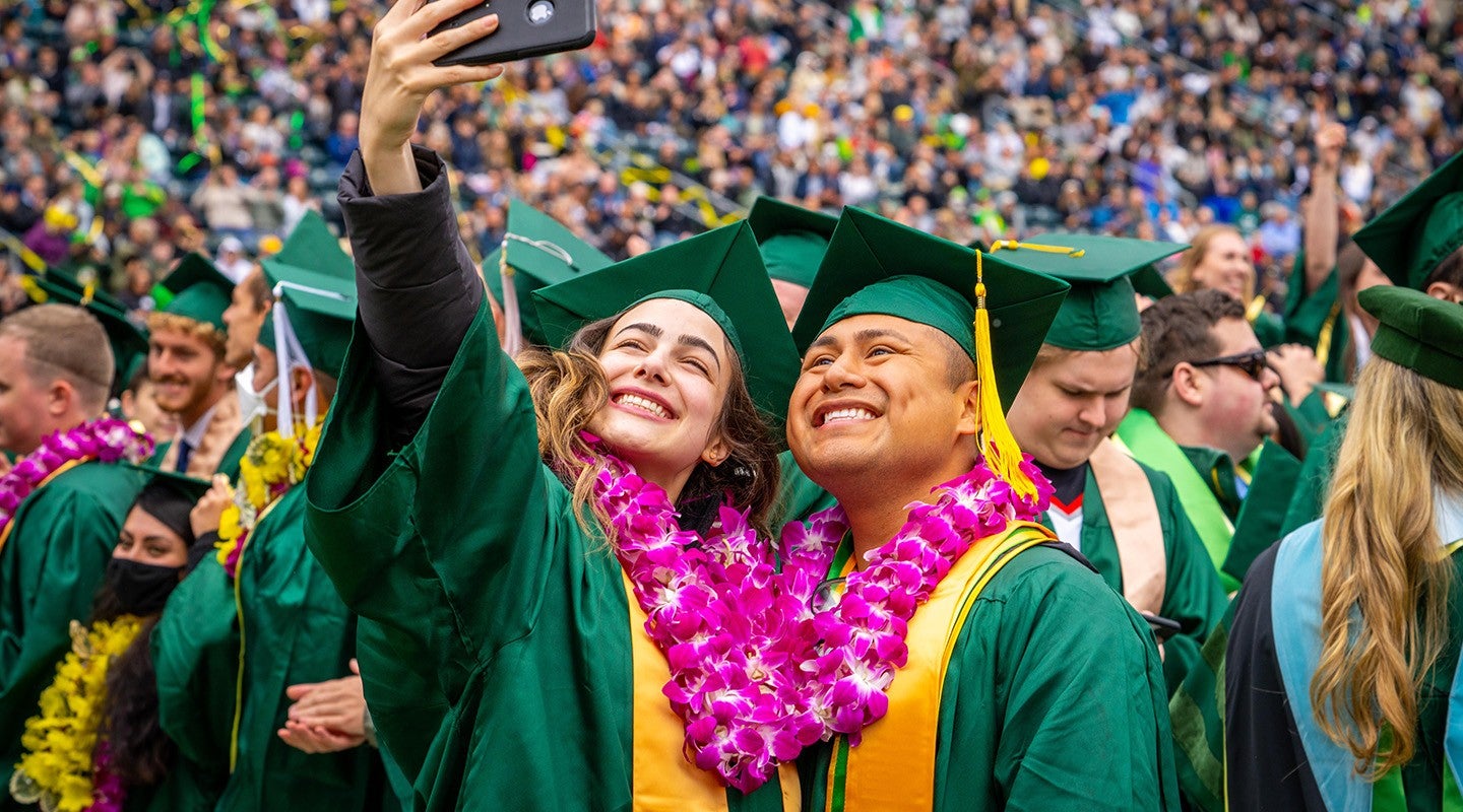 two graduating students taking a selfie