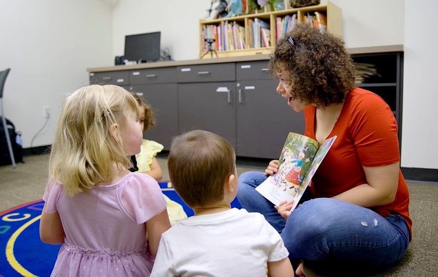 Teacher reading to young children