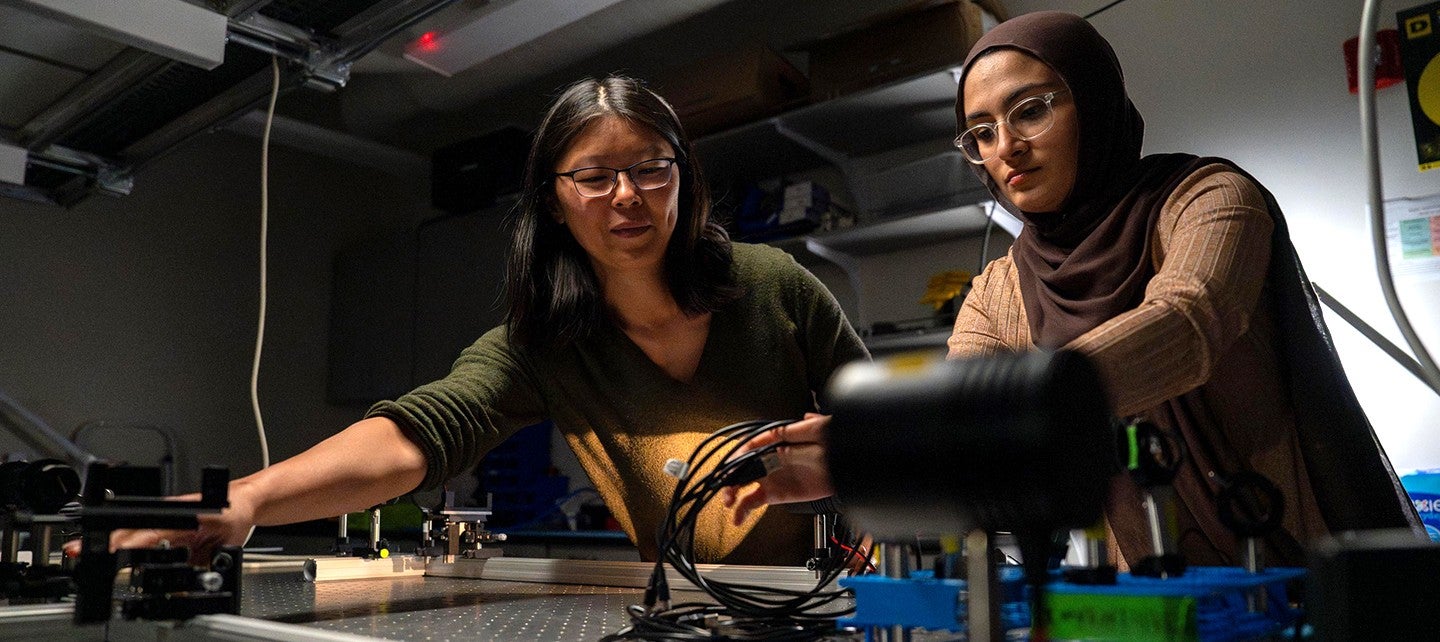 two female student researchers working in a lab