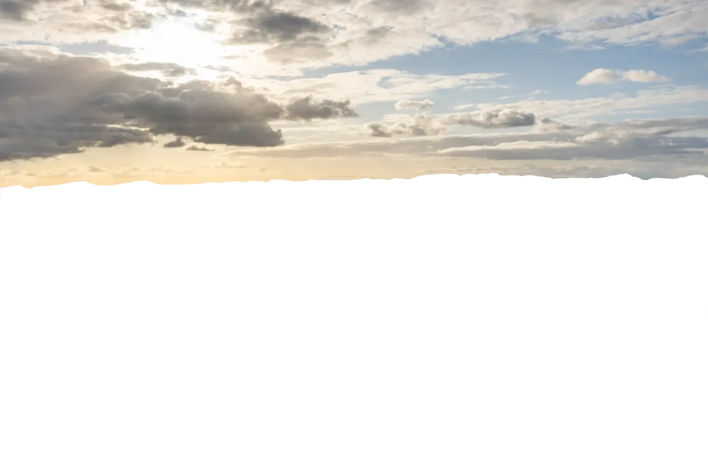 Student standing at Spencer Butte with the sun on the Horizon
