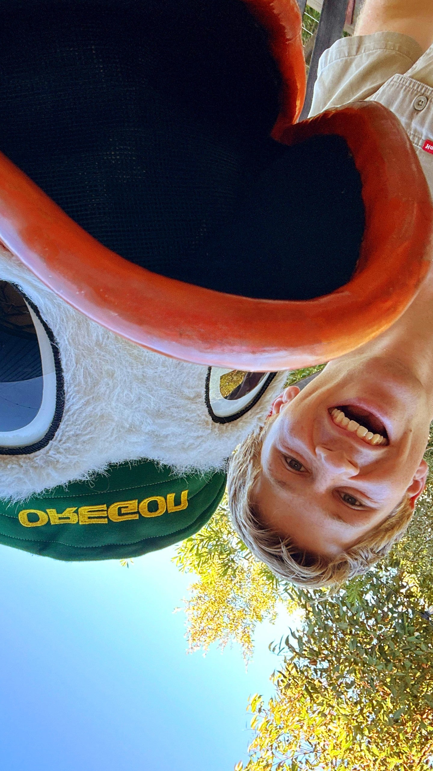 An upside down photo of the Oregon Duck taking a selfie with Robert Irwin