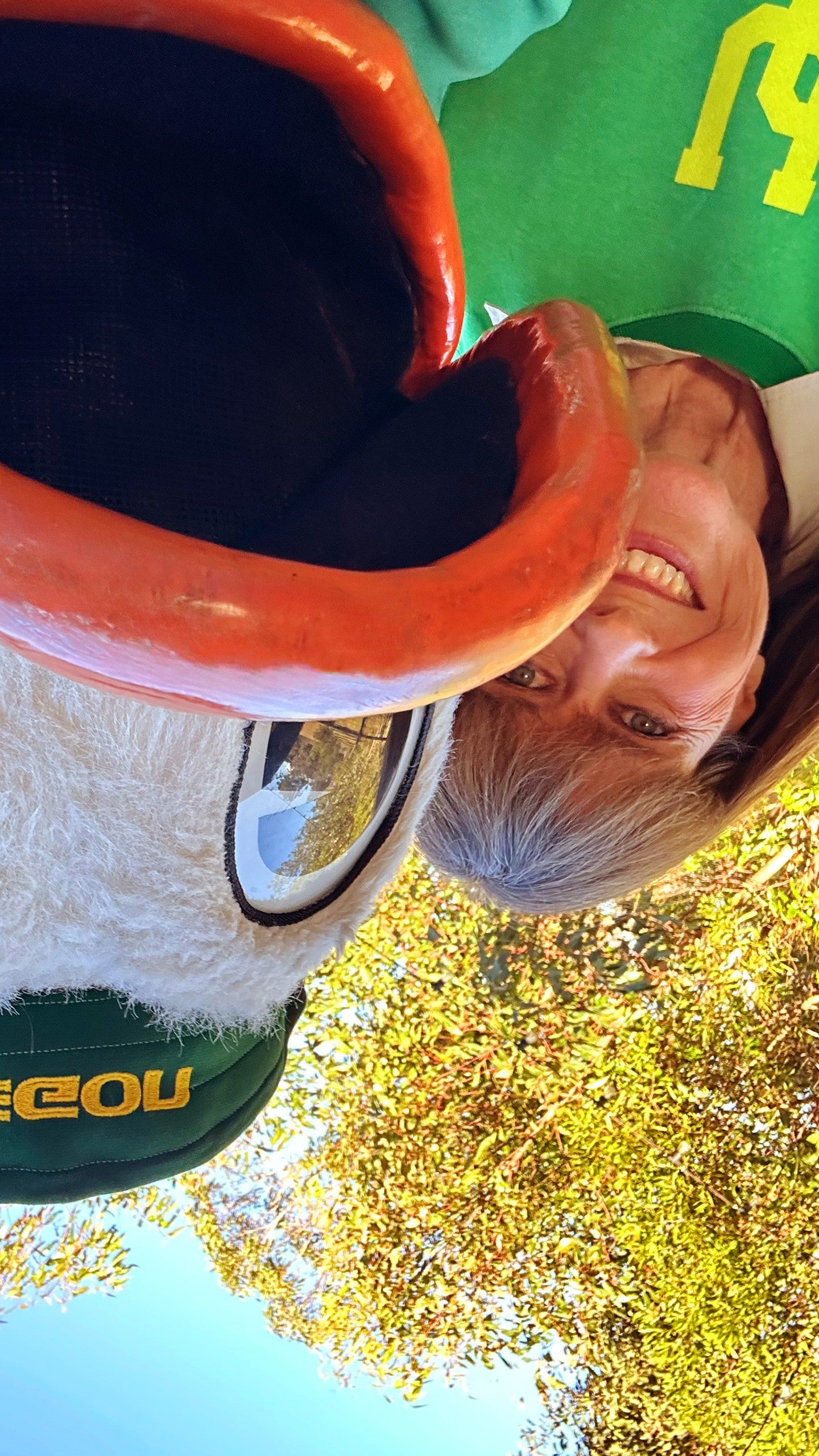 An upside down photo of the Oregon Duck taking a selfie with Terri Irwin