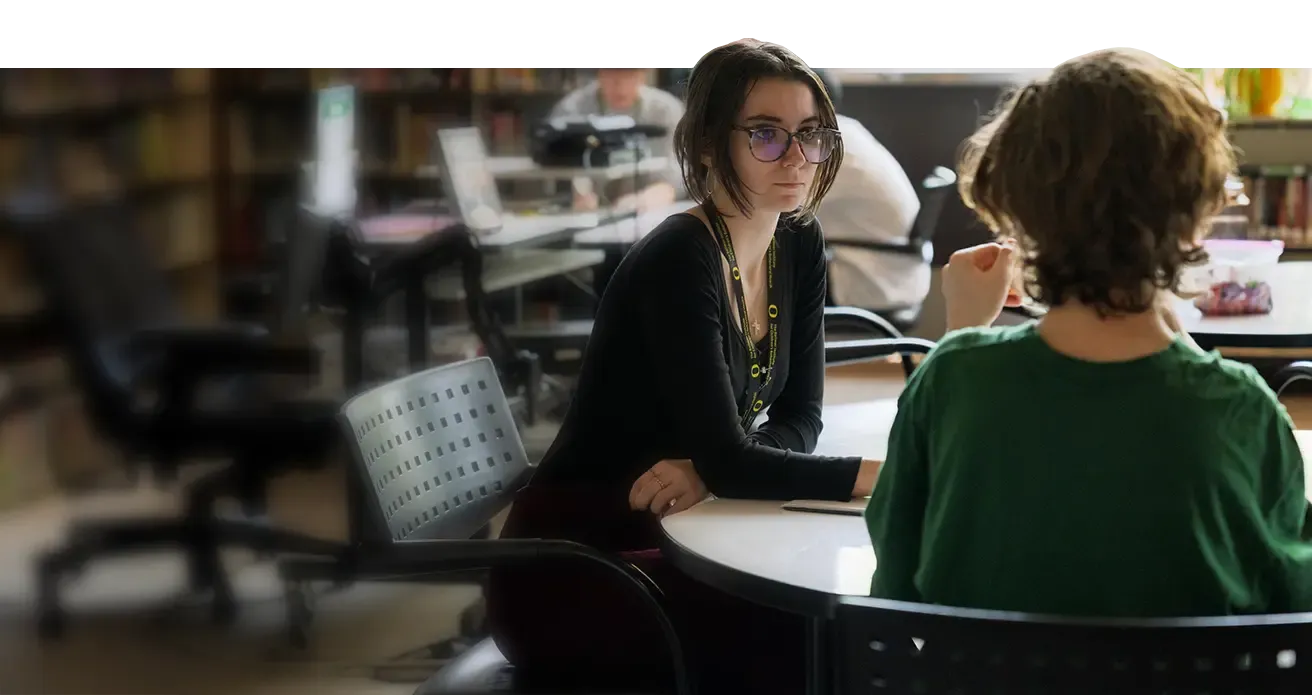 Children's Behavioral Health intern talks with young middleschooler