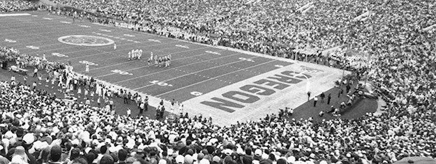 a football game with crowd in the 1990s