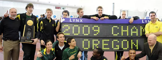 a group of track athletes with a trophy in 2009