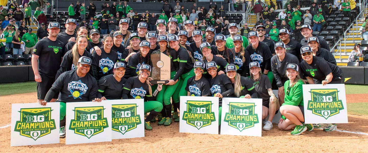 the UO softball team gathers around the 2025 championship trophy