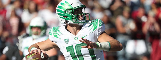 Bo Nix prepares to throw a football during a game