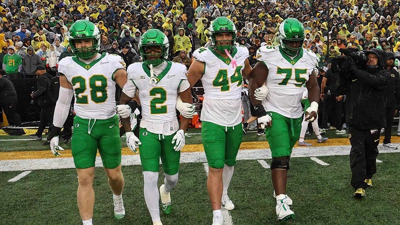 four UO football players at a game