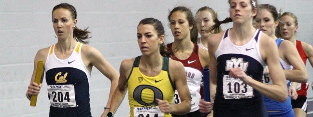 women run at indoor track event