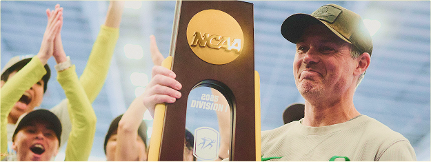 a person holding an NCAA trophy