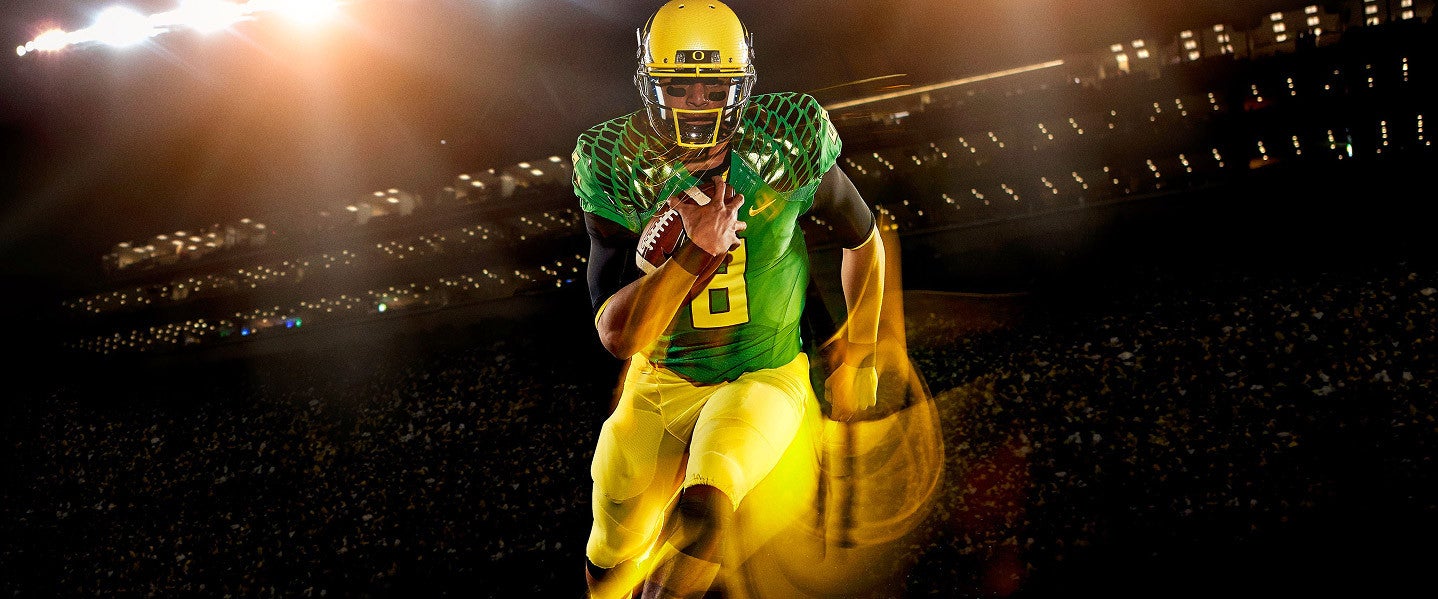 a football player with number 8 jersey runs with the ball