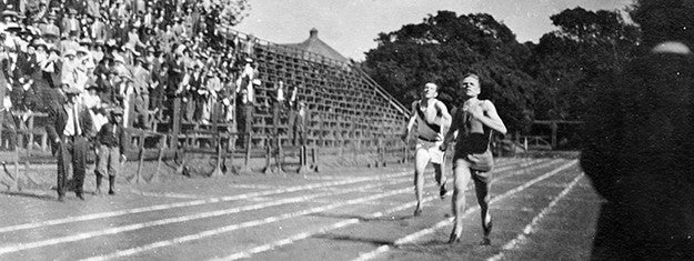 athletes running while a crowd looks on, sometime before 1920