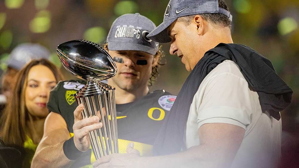 Mario Cristbal and Brady Breeze with the Rose Bowl Trophy