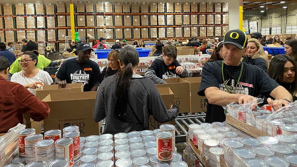 University of Oregon and University of Wisconsin volunteers work at the Food Bank