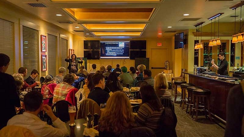 Whitney Wagoner, director of the UO’s Warsaw Sports Marketing Center, delivering a pub talk on “Super Bowl unveiled: Behind the business of the big game"
