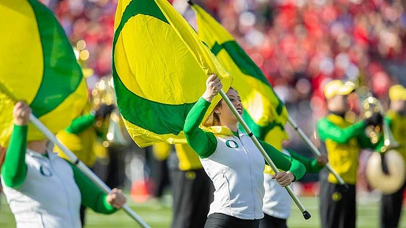 The Oregon Marching Band flag corp performing during the Rose Bowl