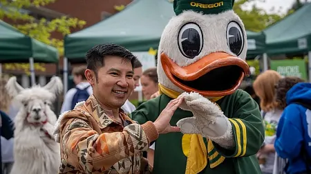 Male student holding up the O sign with the Duck