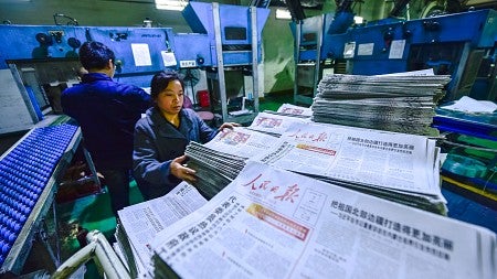 Workers in a Chinese newspaper printing factory. Links to OregonNews: Study finds a rising tide of propaganda in China