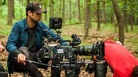 Jake Swantko behind a camera outdoors