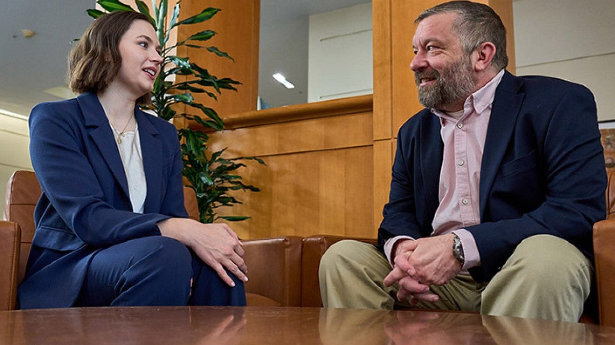Haley Cook, a 2025 Oregon Law graduate, talking to Paul Binford, the staff attorney for the Domestic Violence Clinic