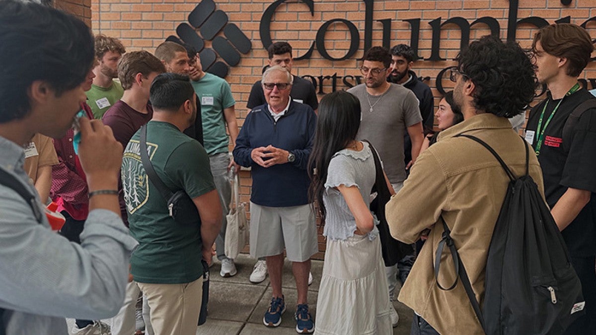 Students standing in front of Columbia Sportswear wtih CEO Tim Boyle