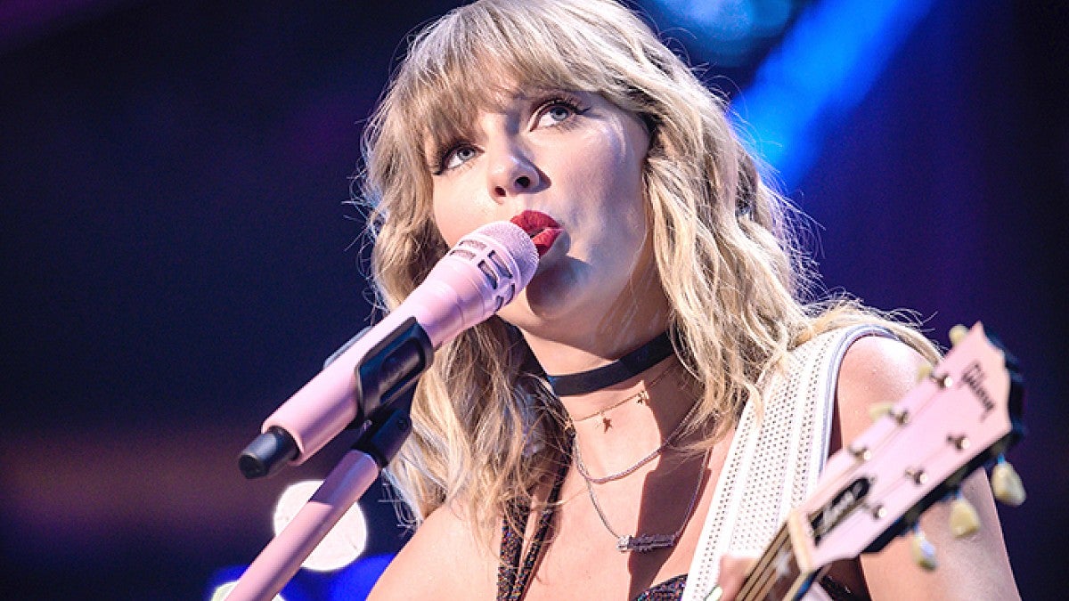 Taylor Swift singing into a microphone