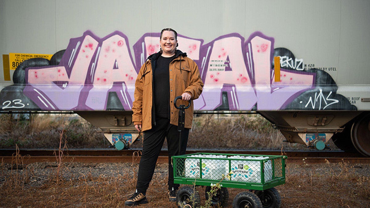 Sarah Koski poses with water bottles in the "Koski Cart"