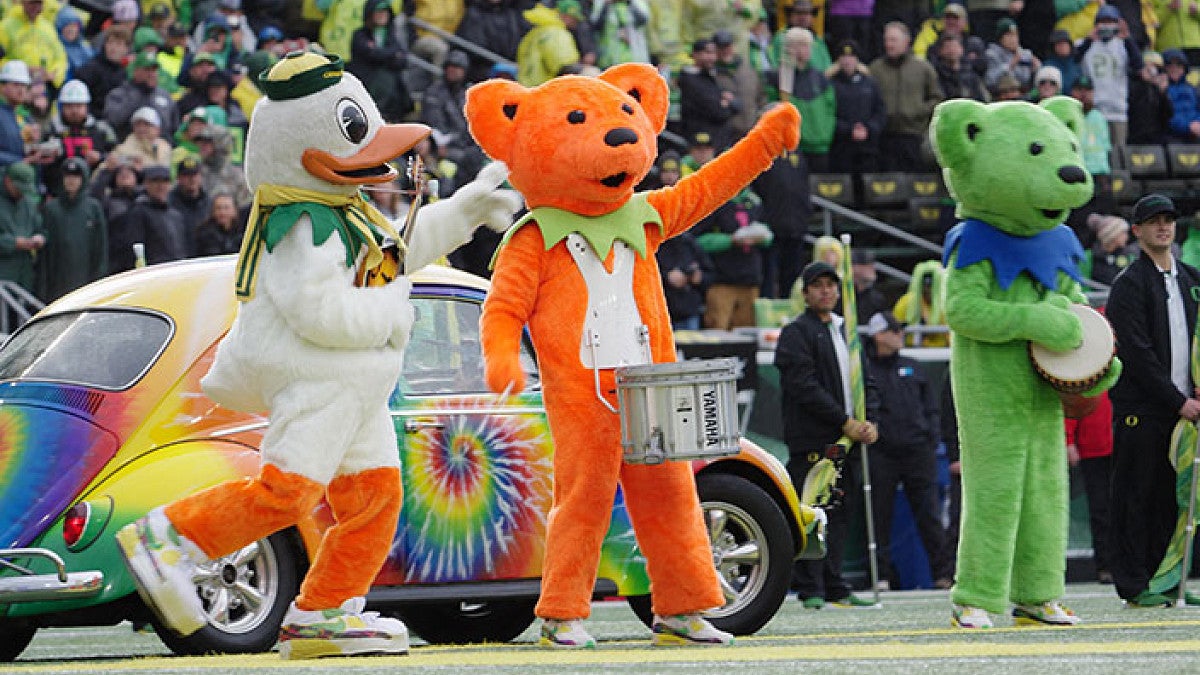 The Duck mascot interacts with dancing bears in Autzen Stadium