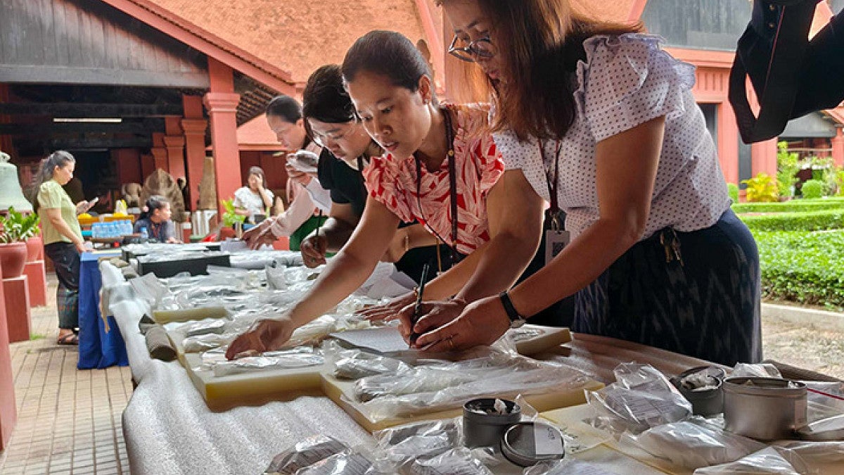 People unpacking Cambodian artifacts at the National Museum of Cambodia