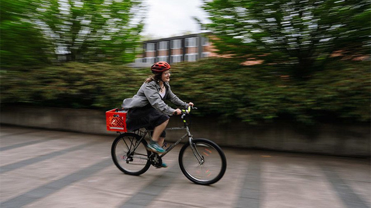 a person riding a bike on campus