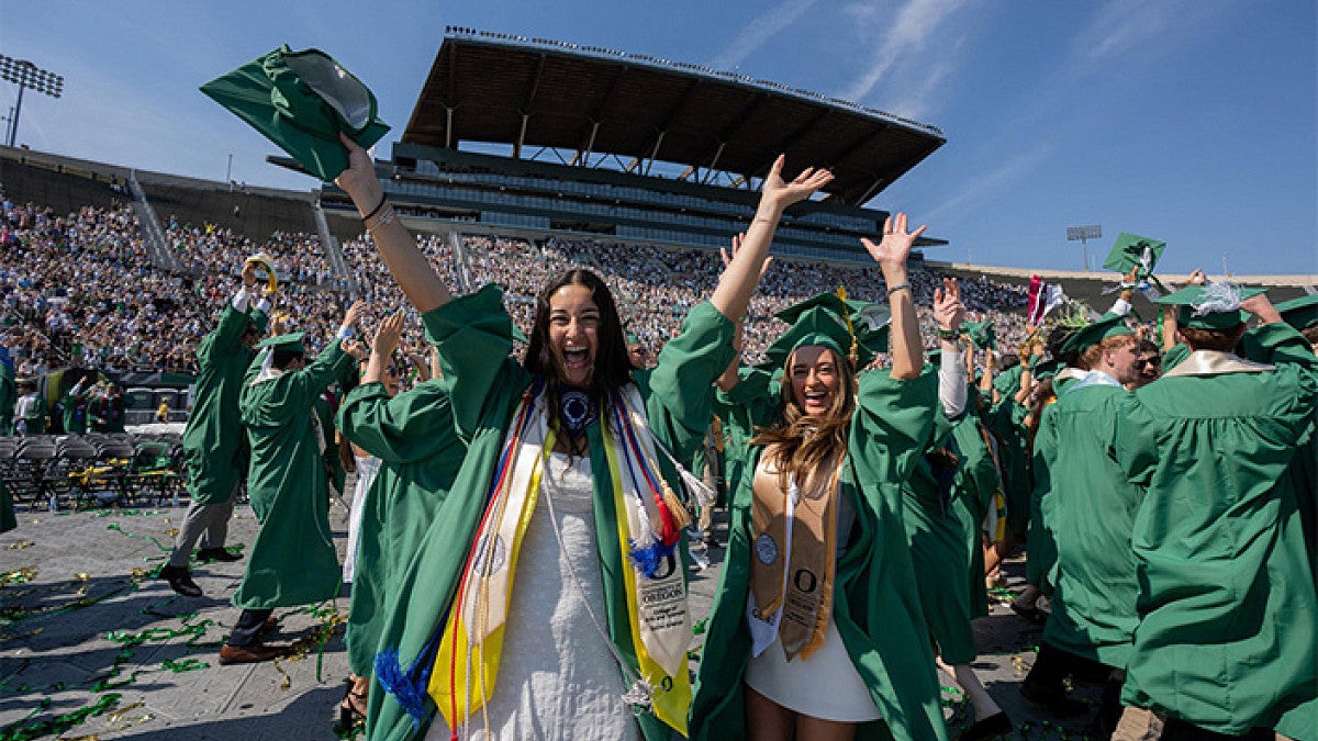 2026 graduating students celebrate during commencement in Autzen Stadium