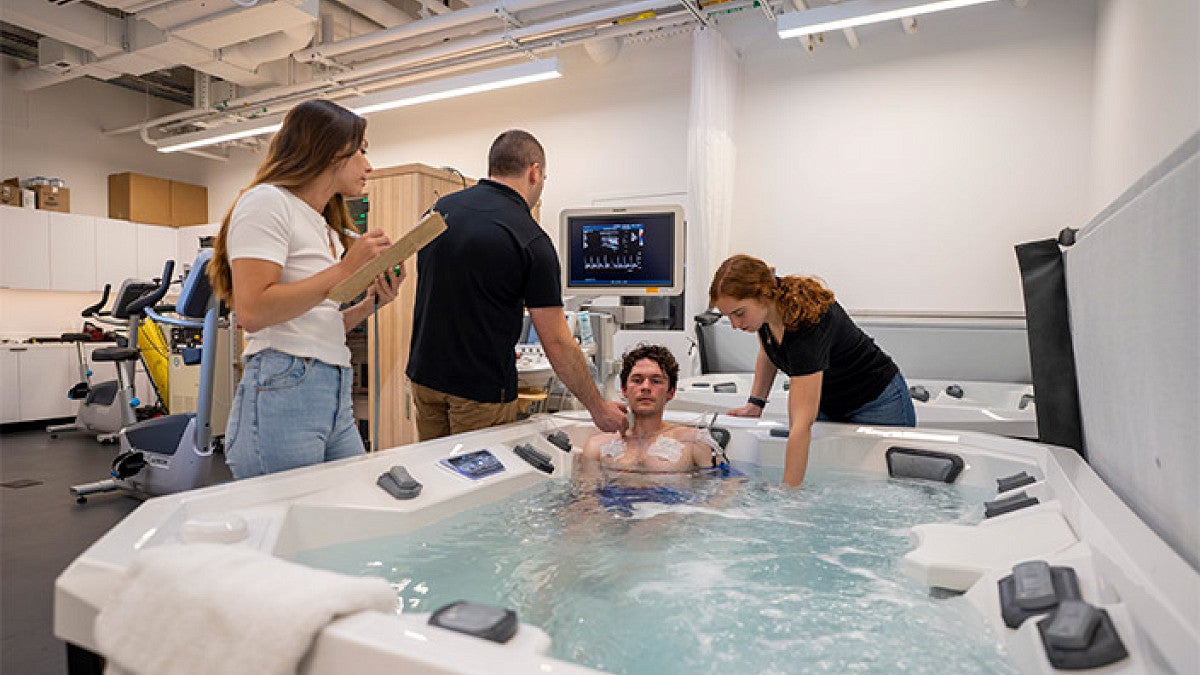 scientists gather data on athlete in hot tub