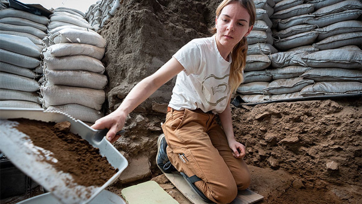 a student digs at a research site