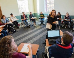 Clark Honors Class has small class sizes with a maximum of 19 students per class Students sitting in desks in a circle in a small class