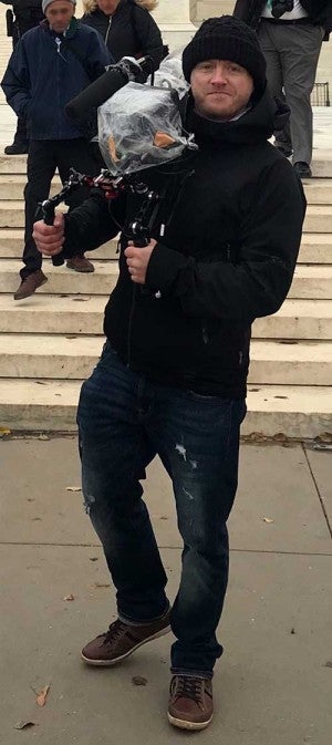 Adam Markle holding a video camera