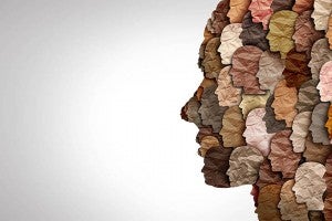 Collage of faces in the shape of a face silhouette