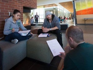 Students studying by the fireplace in the HEDCO building