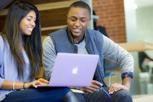students looking at laptop
