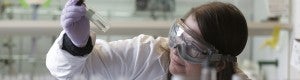 Susan Cooper holding a test tube in a chemistry lab Susan Cooper holding a test tube in a chemistry lab