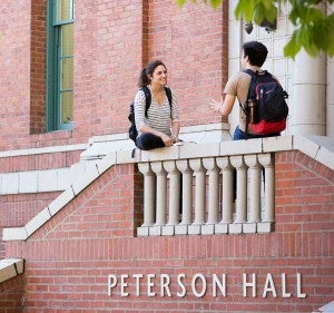 Two students sitting outside Peterson Hall Two students sitting outside Peterson Hall
